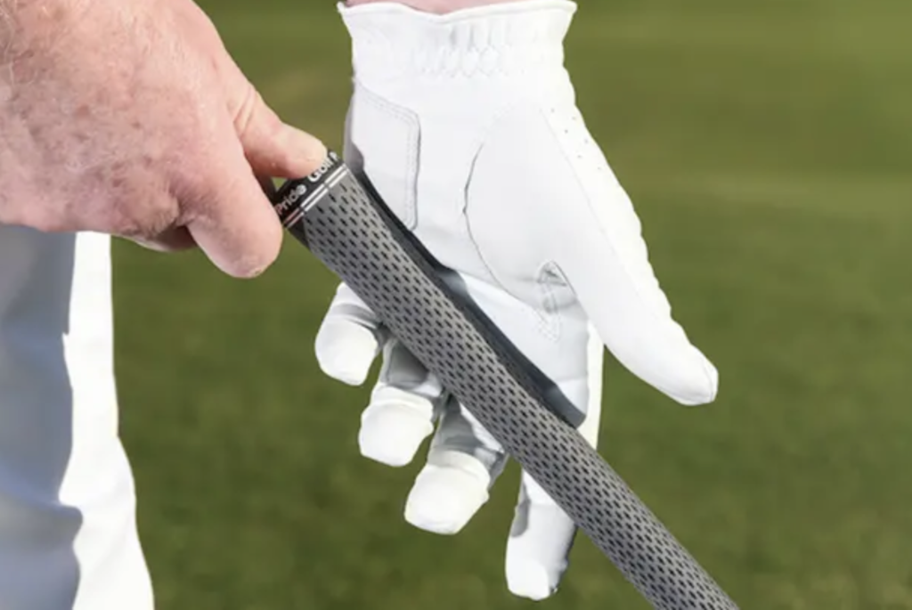 A hand wearing golf gloves holding a golf stick with left hand