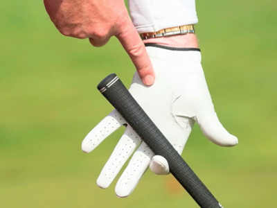 A person indicating towards the palm of their hand wearing golf gloves