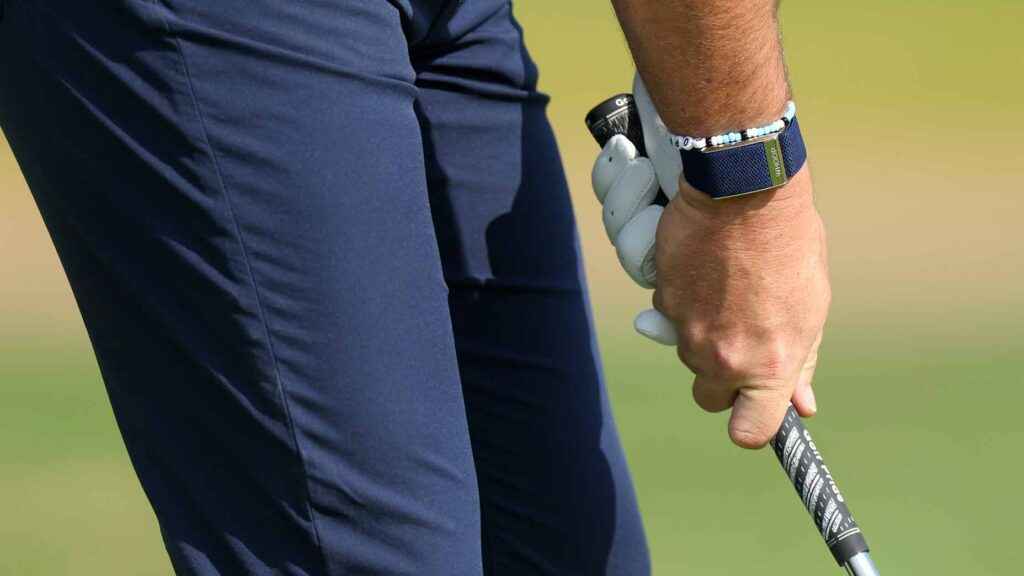 A person tightly gripping the golf club