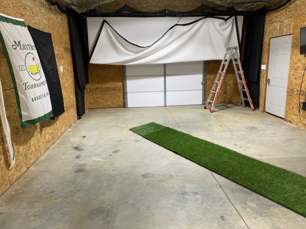 A screen being set up for garage gold simulator