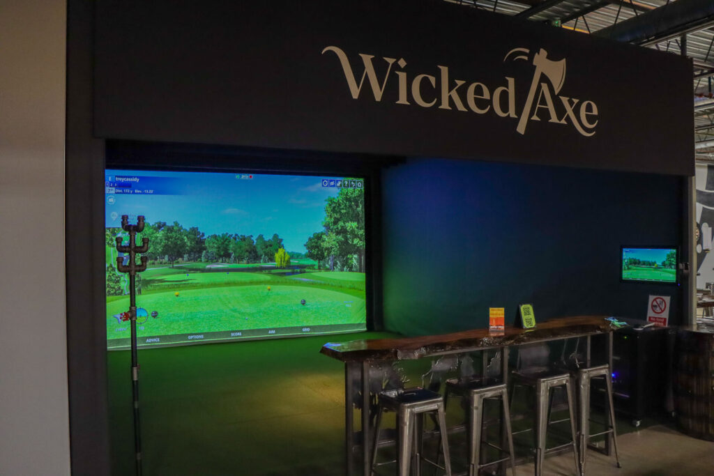 An indoor Wicked axe simulator enclosure with screen monitor