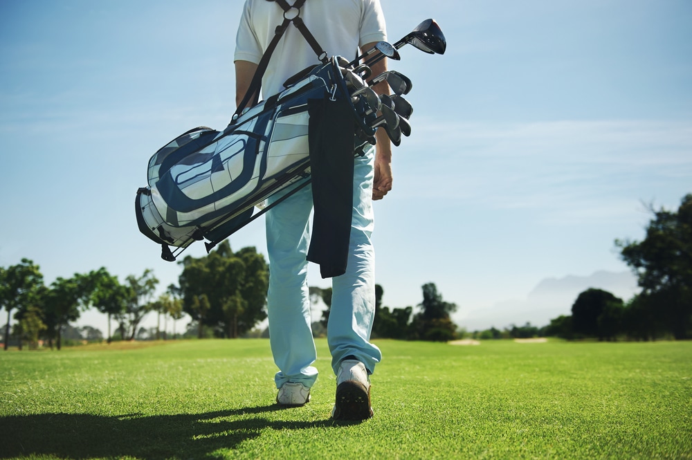 a golf caddy walking on the ground