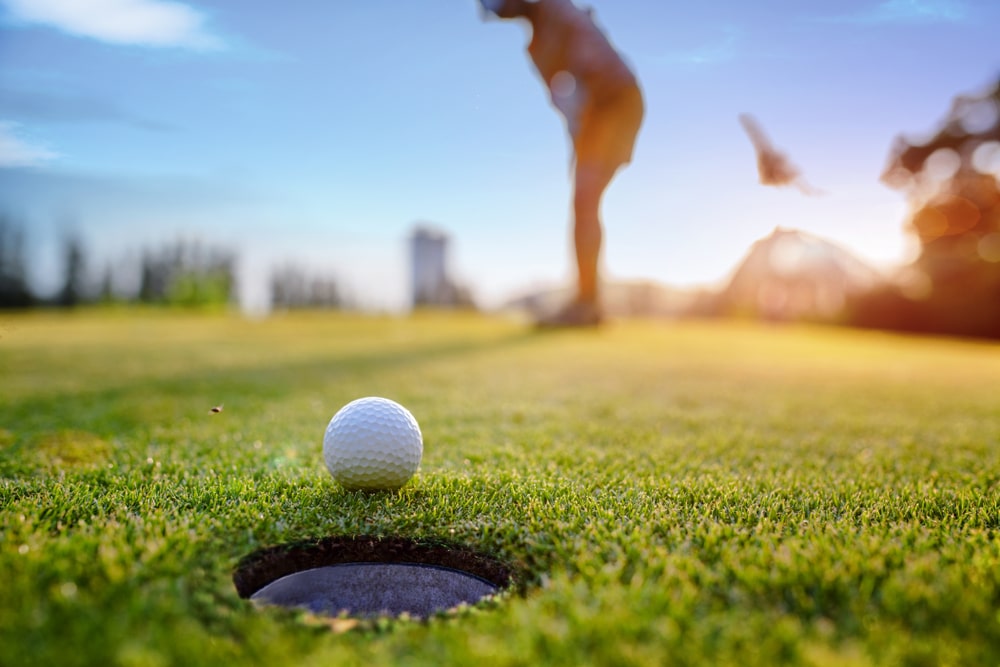 Golf Ball Approach To The Hole On The Green Putting