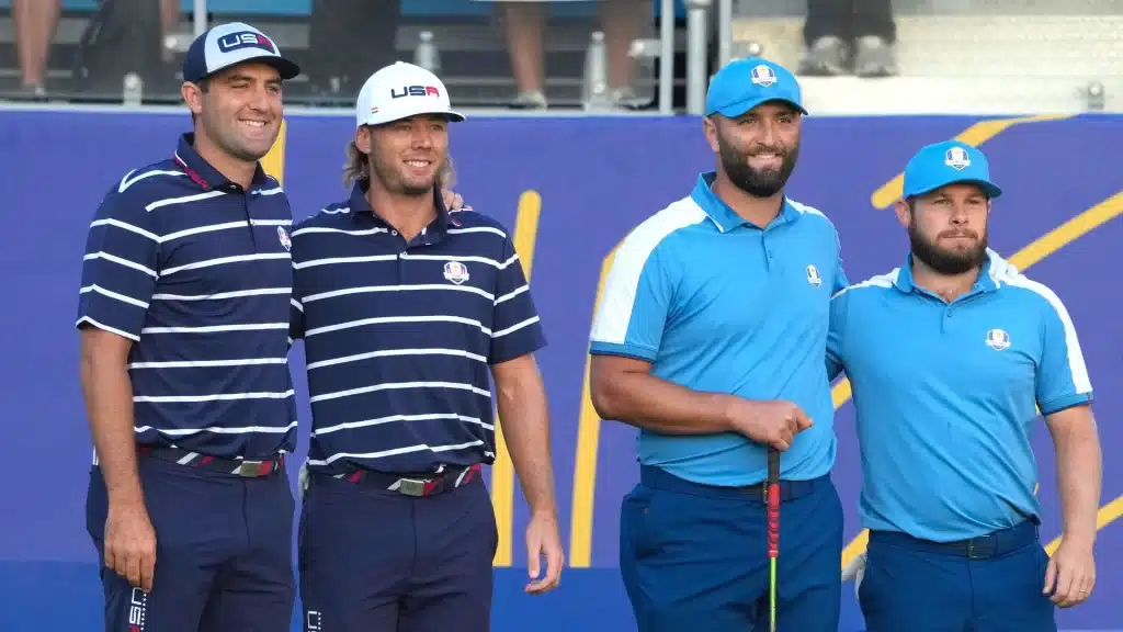 four professional happy golfers standing