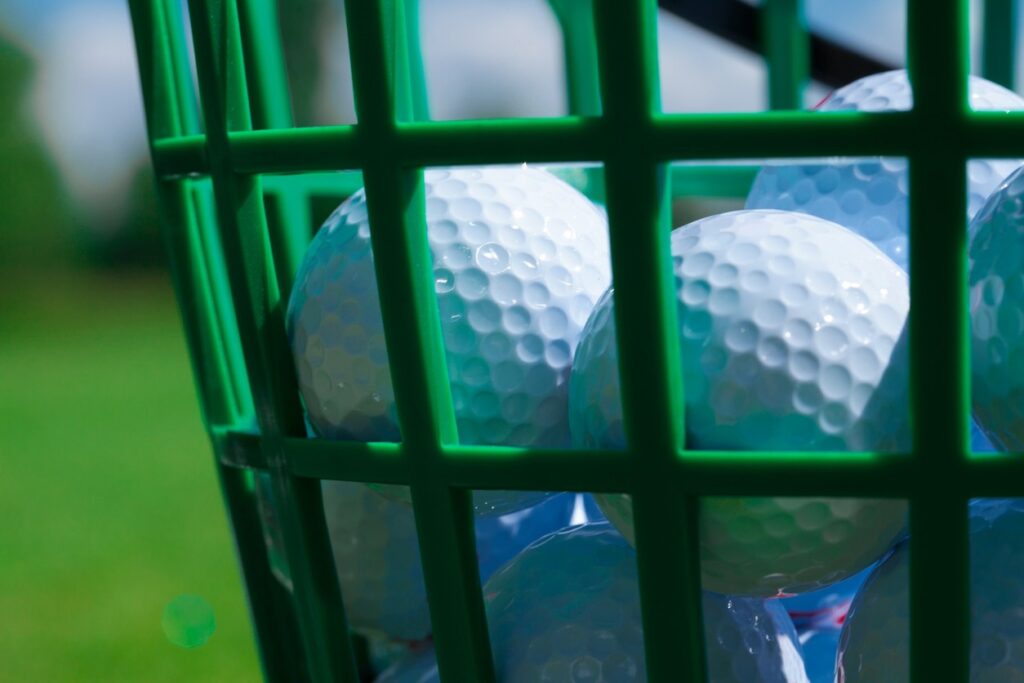 A close view of golf balls placed in a basket