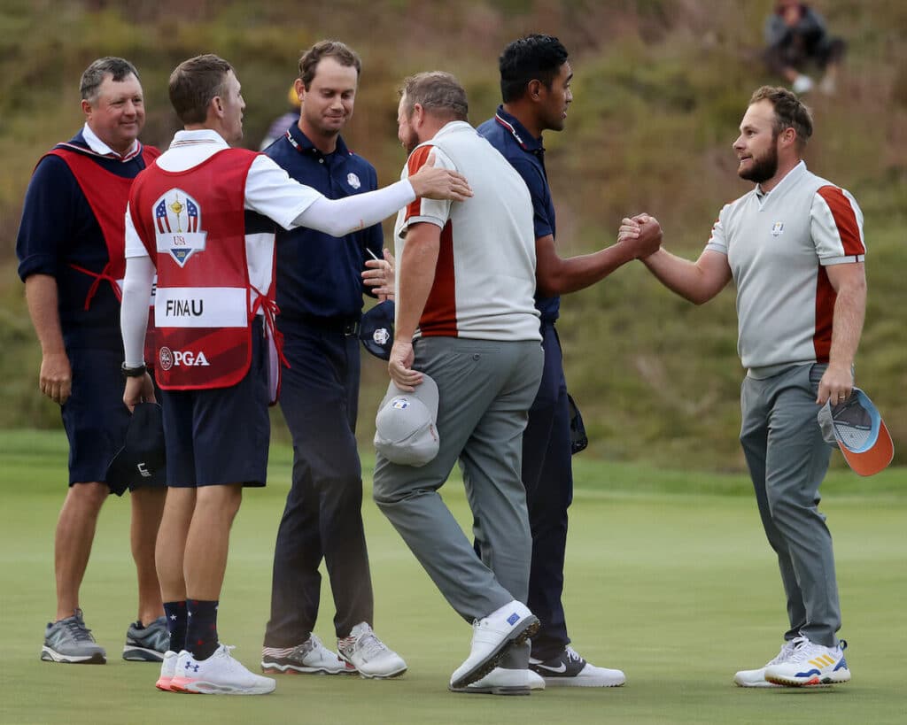 A golf team cheering together