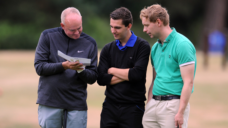 A person showing the golf scorecard to other two golfers