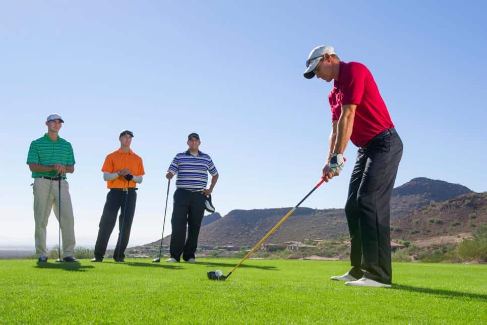 Four people playing ball golf at a golf course