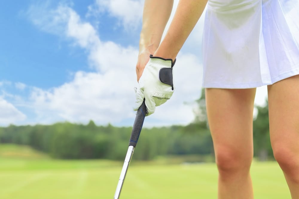 A view of a lady holding a golf club