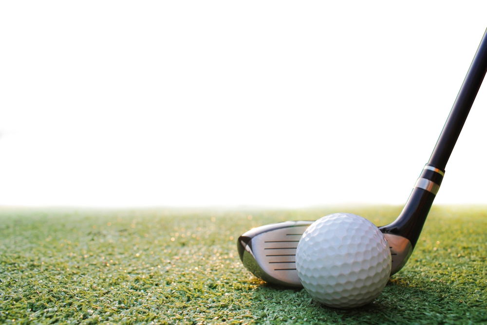 A view of a golf club hitting a ball