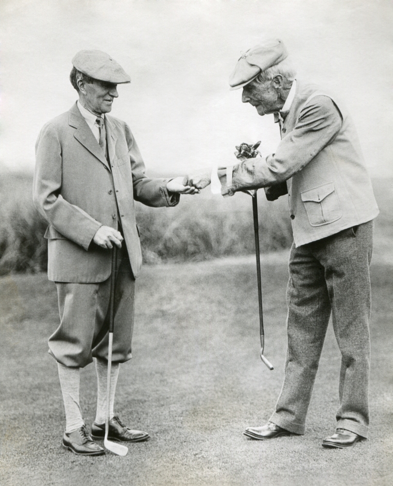 A view of two people in history playing golf