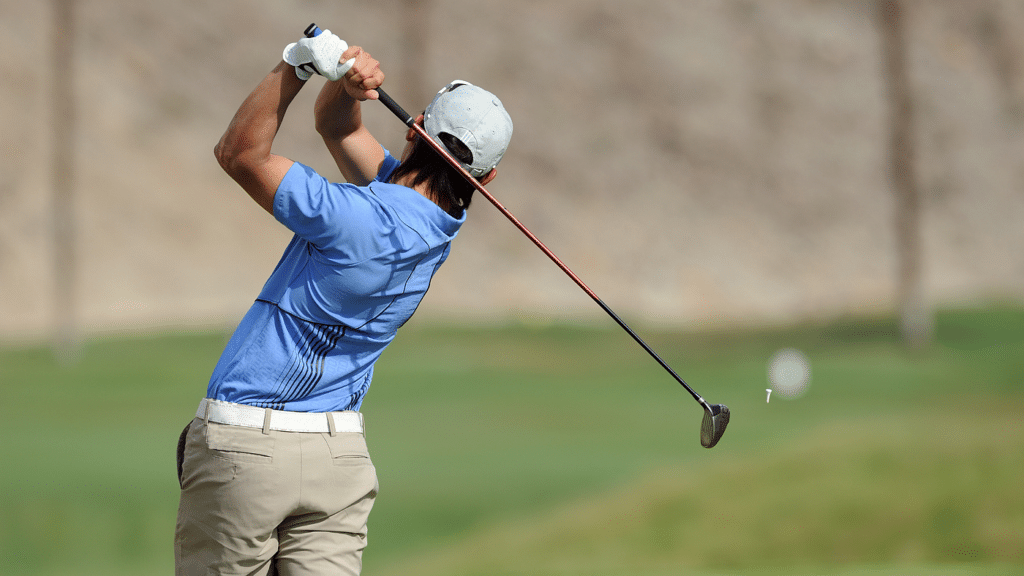 a professional golfer making a shot with a club gripped perfectly