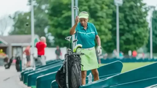 a senior golfer putting teh golf club in the bag