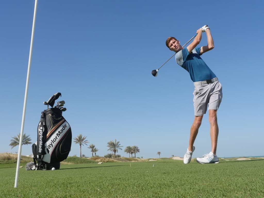 a young golfer hitting draw with driver