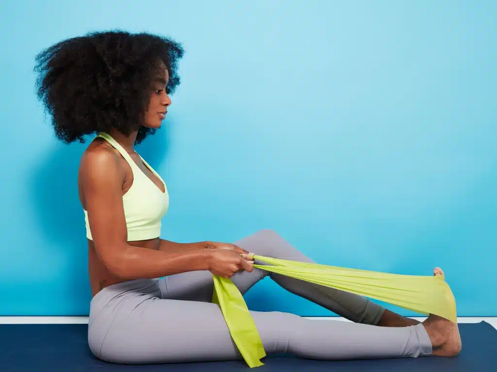 girl dooing calf stretches with a cloth