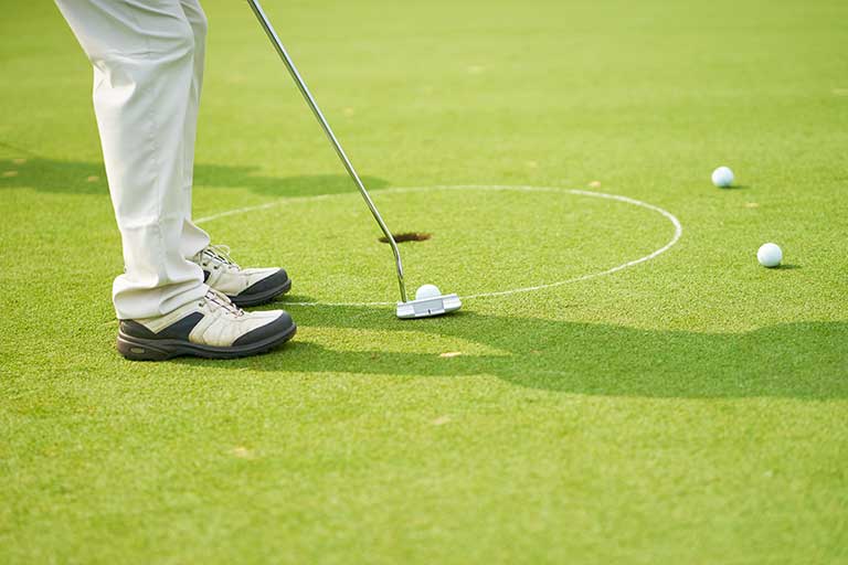 view of a ground with a circle drawn on it and balls around the circle 