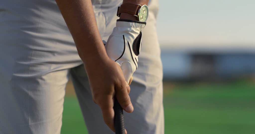 zoomed in view of golfer gripping the club