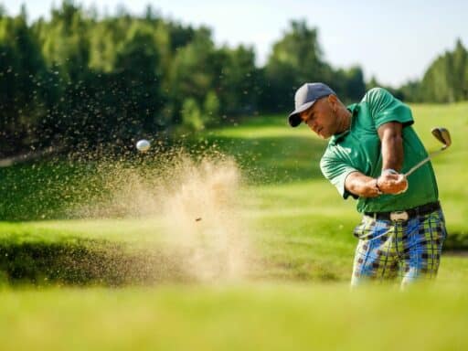 Golfer Hits Ball From A Bunker With Golf Club Golfer