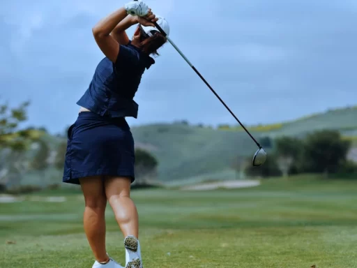 a female is playing golf