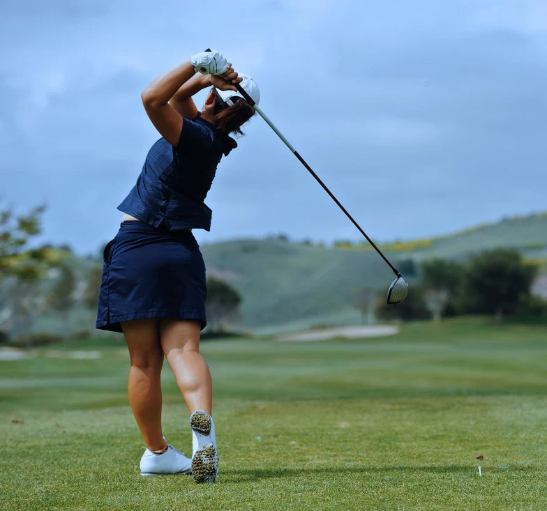 a female is playing golf