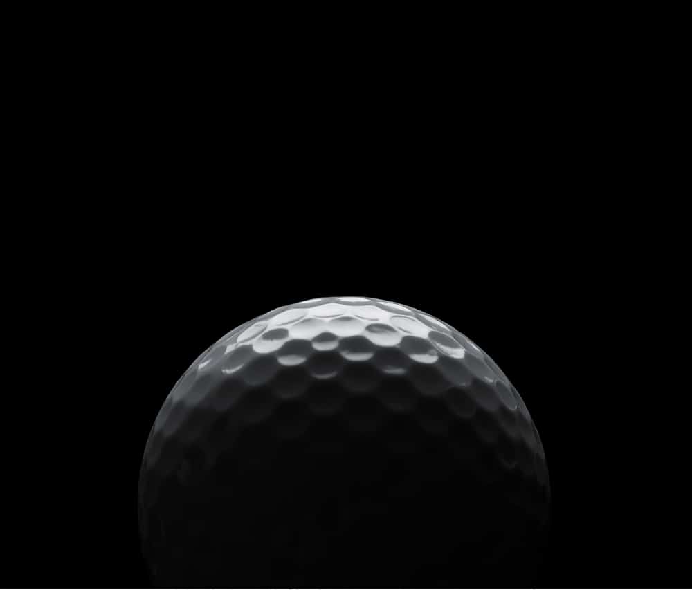 Golf Ball On Black Background With Copy Space