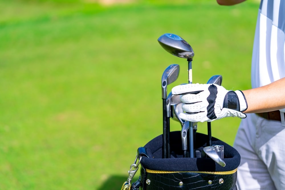 Confidence Asian Man Golfer Choosing Golf Club In Golf Bag