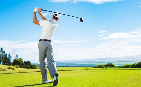 Male golfer standing at tee square on course