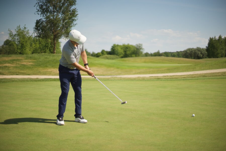 golfer putting on green golf course