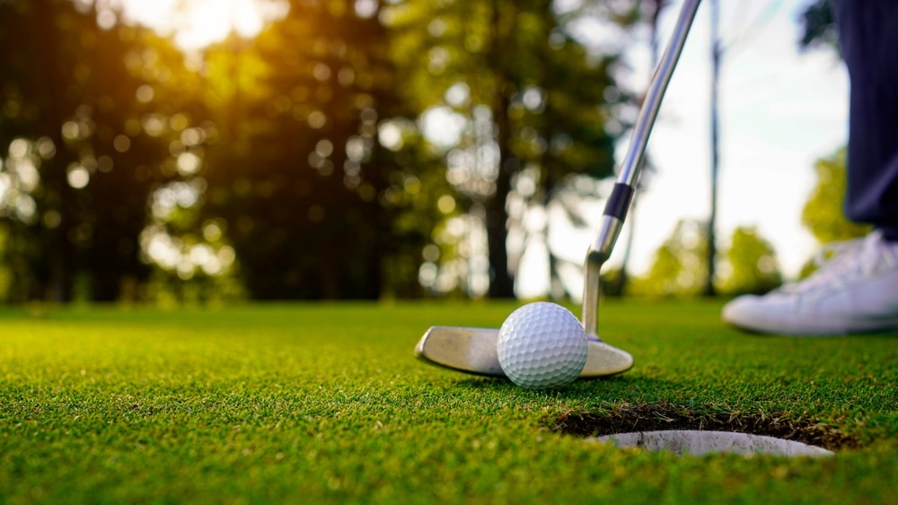 Blurred Golfer Playing Golf In The Evening Golf Course On