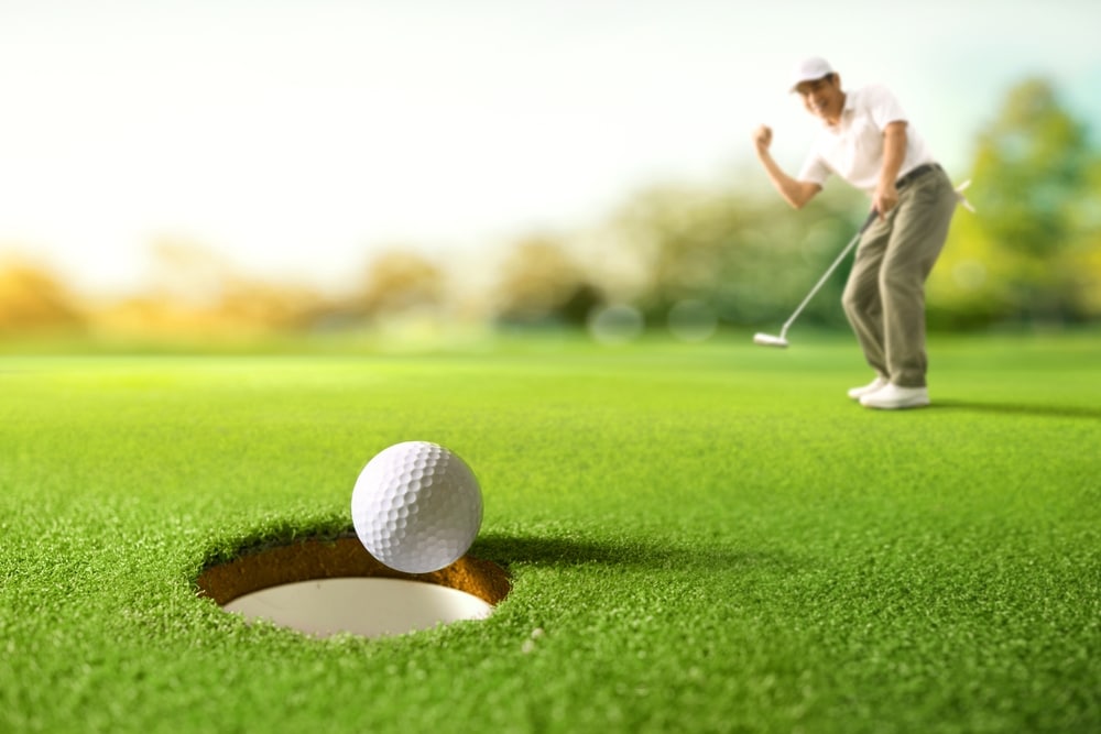 Golf Ball Drop Into The Hole After Golfer Putting