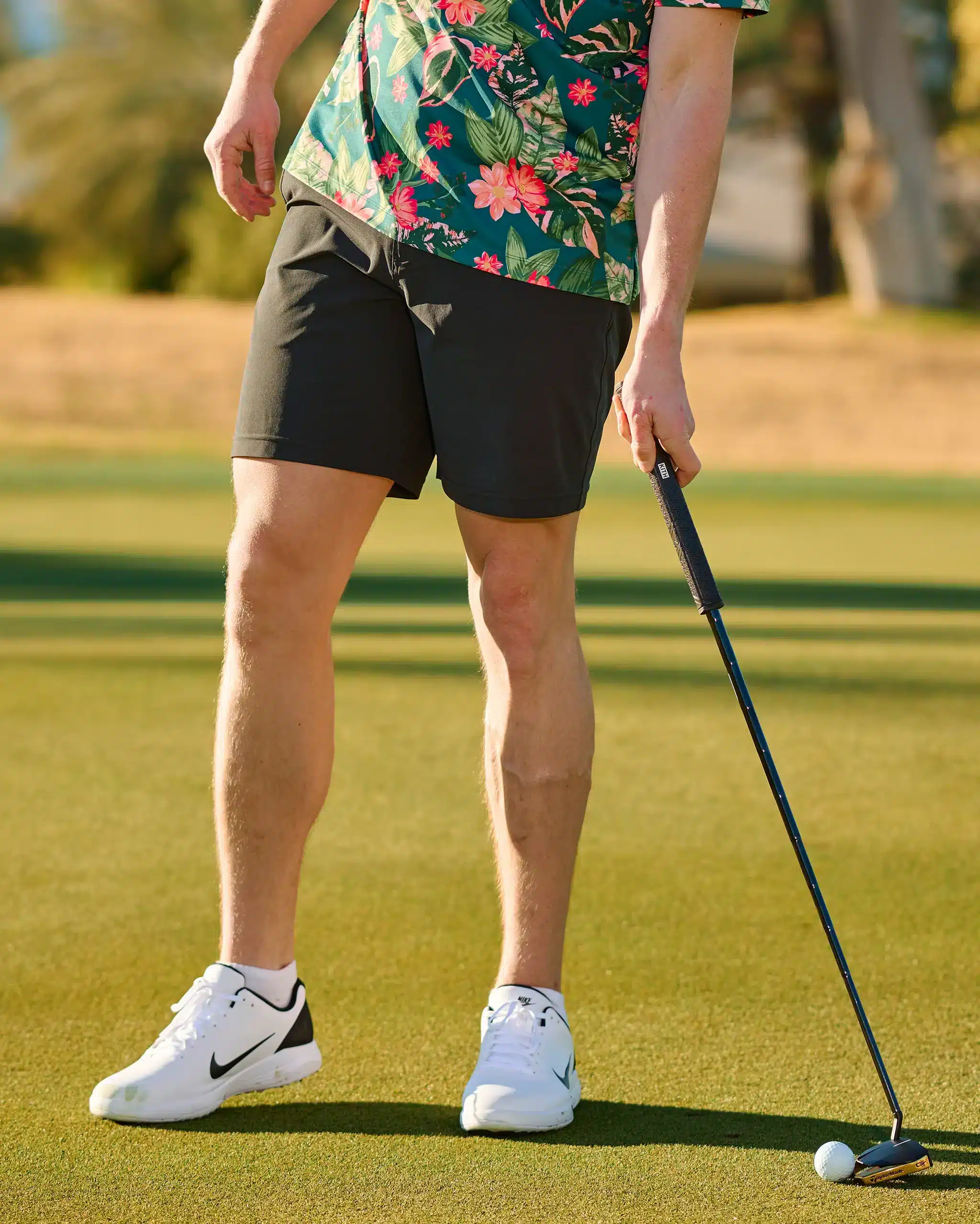 man playing golf and wearing golf short