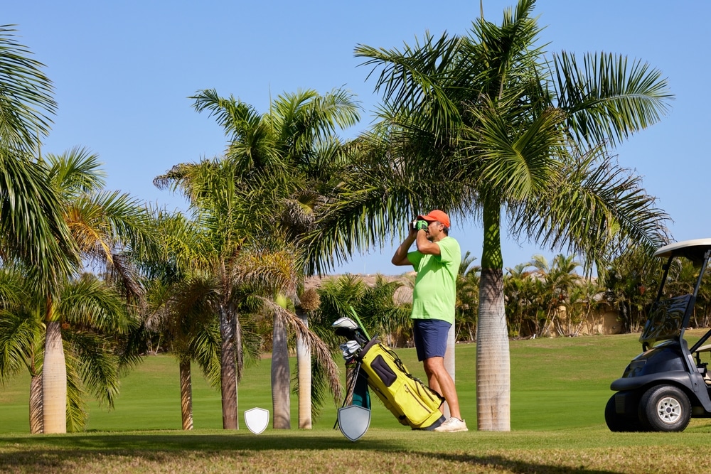 The Golfer Accurately Measures The Distance To The Flag In