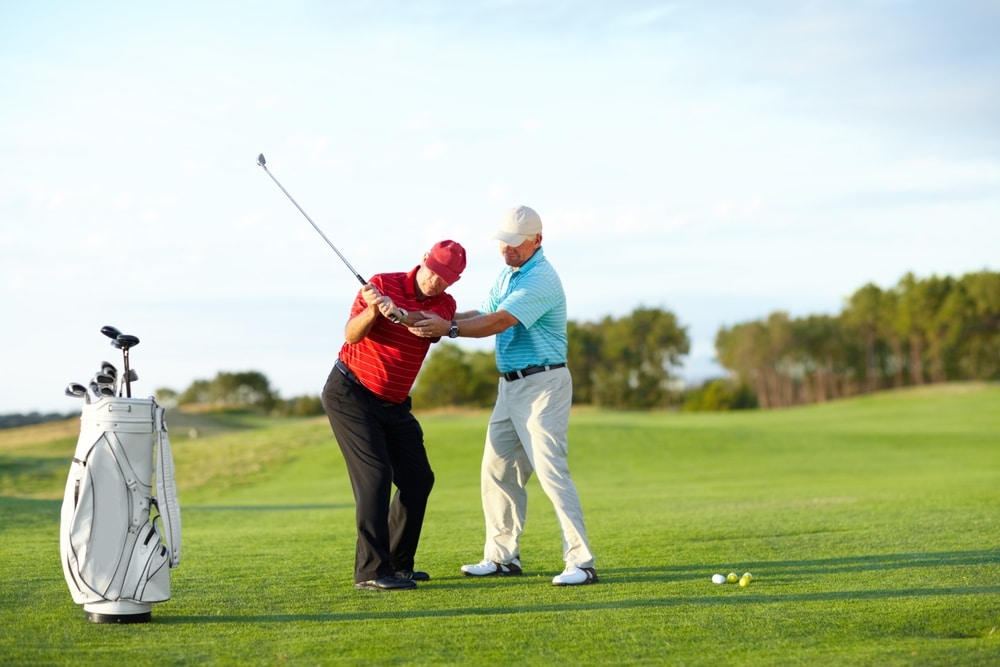 The Correct Technique A Male Golfer Getting Help From His